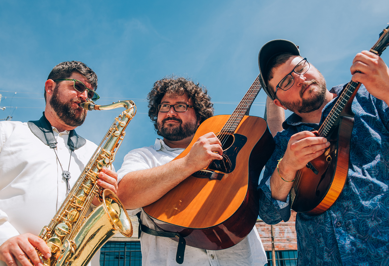 photograph of the Faux Paws playing musical instruments