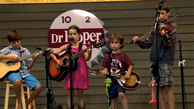 photograph of children playing music onstage at the annual Old Fiddlers’ Convention in Galax, Virginia